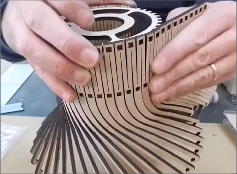 Screencapture of a lamp made of wood via laser cutting found on Youtube. Part of my research was looking for ways I could laser cut a base for the lamp, as I wasn't too sure how to acomplish this. Seeing this one video, and eventually more examples inspires many possabilities. <a href'https://www.youtube.com/shorts/Fl_F_UZUA1A' target='_blank'><p>Link to YouTube short by HappyFamilyMakers</p></a>